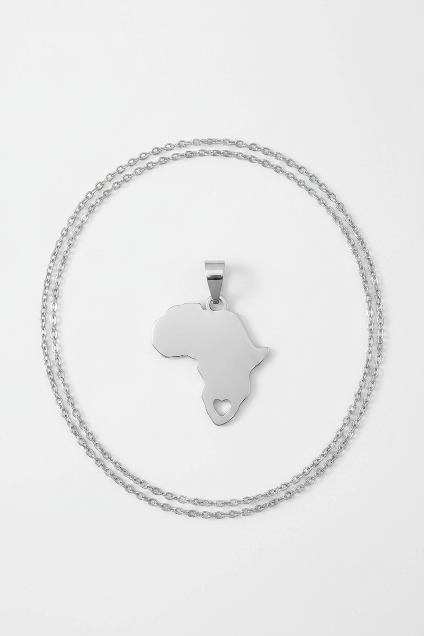 Jovel Nadora Africa Heart Pendant Necklace – flat lay close-up from above with chain arranged around pendant