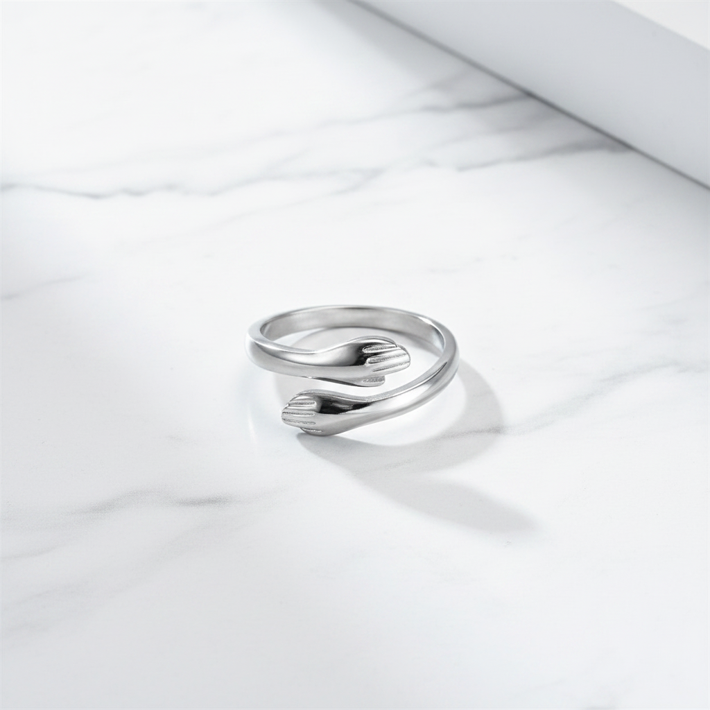 The Embrace Ring flat lay on marble